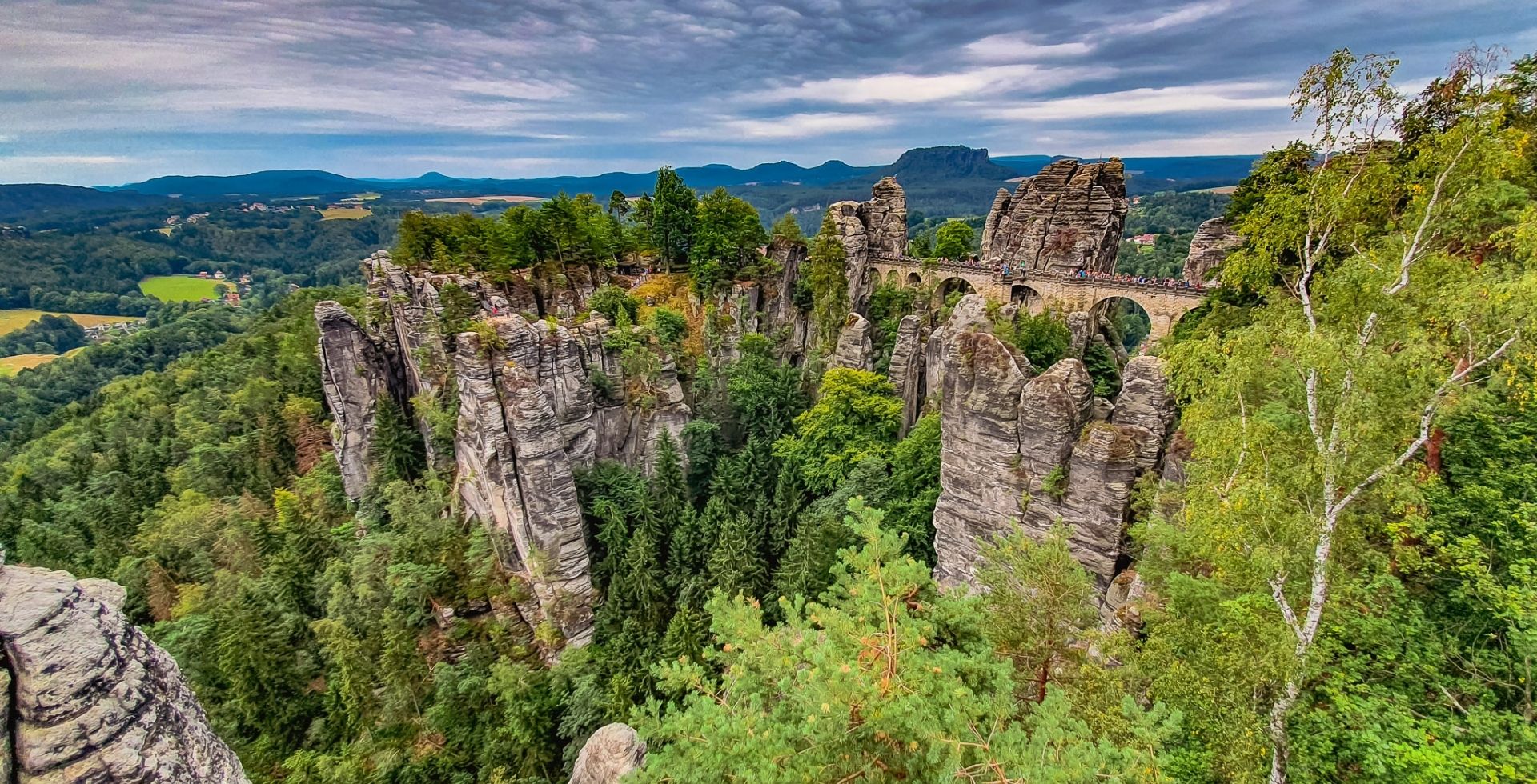Rock formations among greenery in Saxon Switzerland National Park, Germany