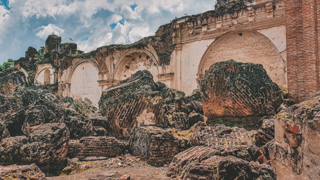 a mass of ruins at La Recolección, only one wall with decorative arches standing in the back