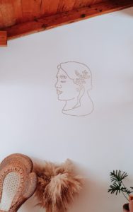 Decoration of a woman's face on a white wall at Artista de Café in Antigua Guatemala