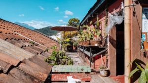 Charming rooftop cafè in Antigua guatemala with wooden tables and chairs and sunbrellas