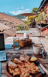 breakfast and laptop on a table at a rooftop cafe in Antigua Guatemala