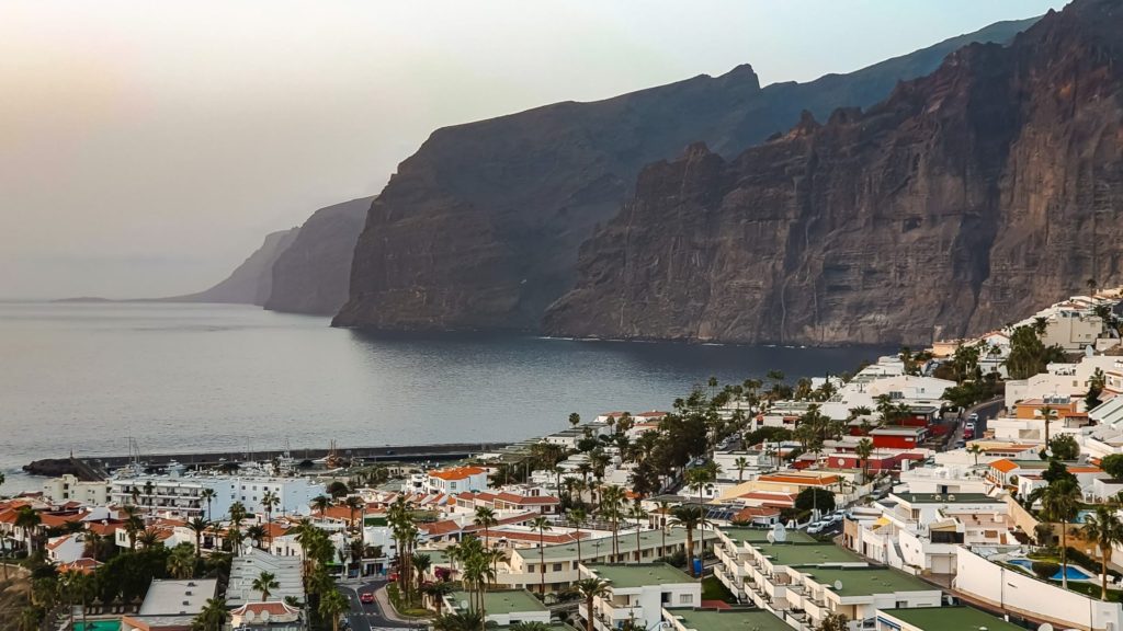 Los Gigantes Cliffs Los Gigantes Cliffs - towering cliffs diving into the ocean in the background and a small town with white houses in the foreground