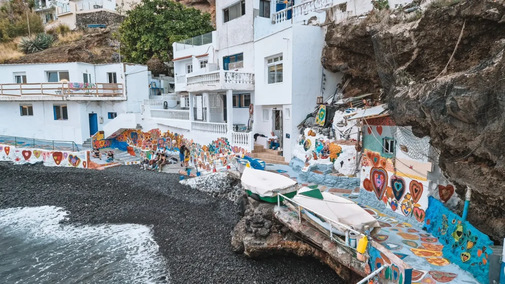 Boca Cangrejo beach with hearts A small bay enclosed by cliffs and whitewashed houses partially covered in colorful hearts