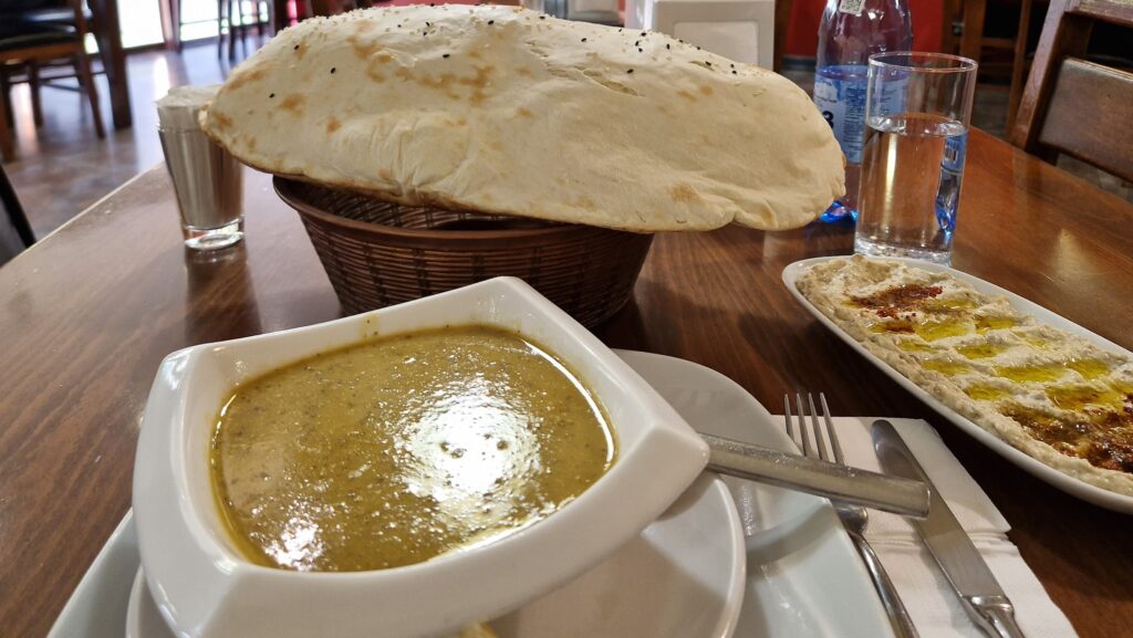 Bowl of soup, lavash bread, and moutabal