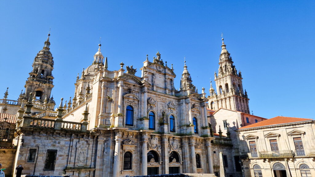 Santiago de Compostela Decorative historic cathedral facade with ornate towers and pinnacles under a clear blue sky, Santiago de Compostela