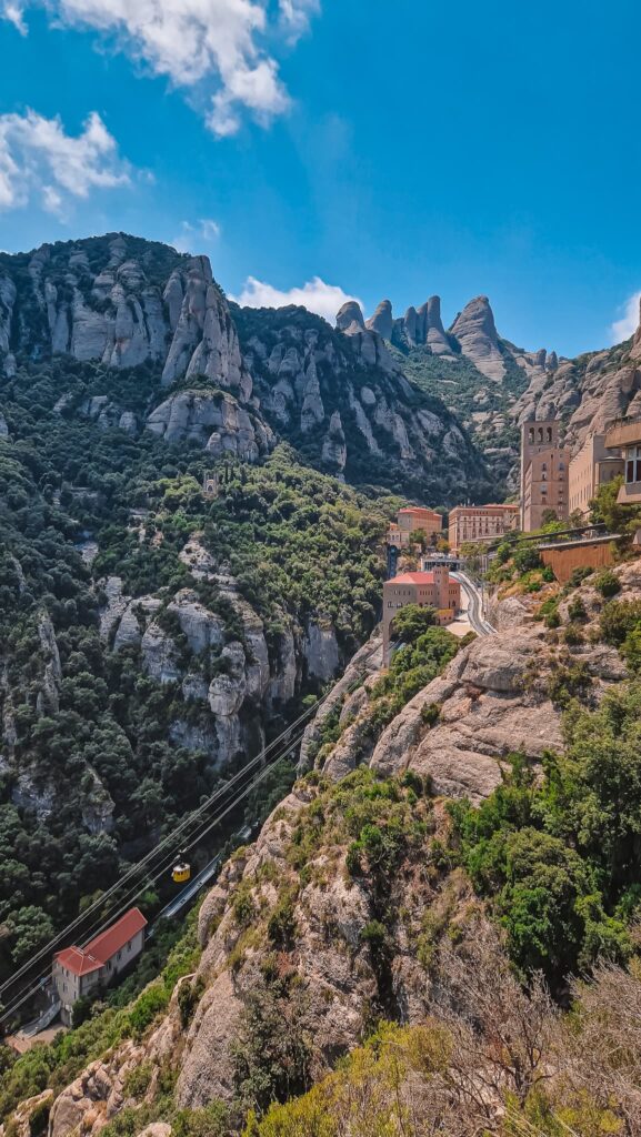 Montserrat Steep rocky Montserrat mountains with a cable car and buildings perched along the cliffside.