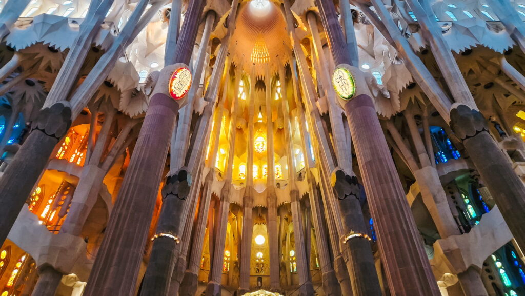 Sagrada Familia columns Interior of the Sagrada Familia with tall columns and stained glass windows