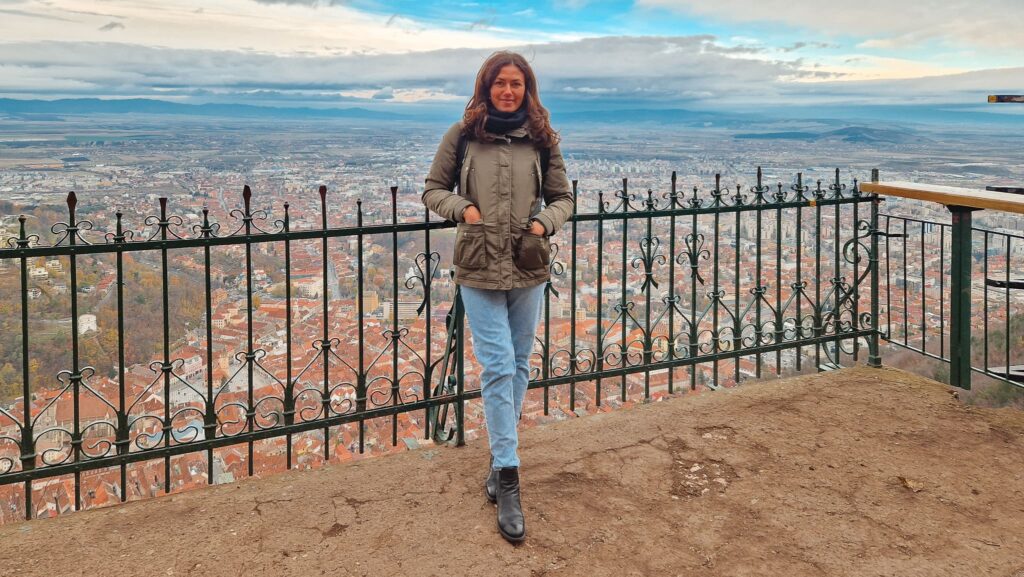 Rox, Brasov Woman standing on a viewing platform looking over Brasov, Romania