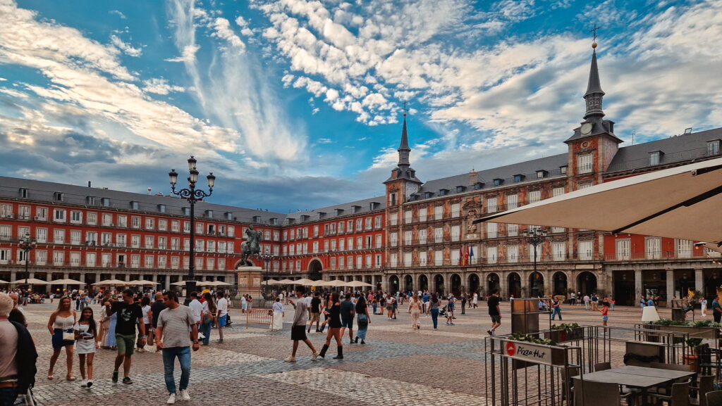Plaza Mayor Madrid Plaza Mayor, square in Madrid surrounded by red buildings - European cities to visit in autumn