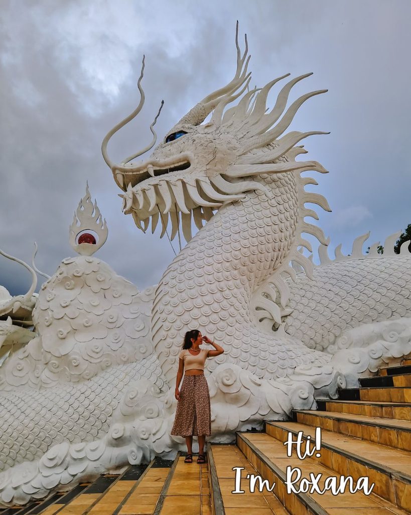 Hi! I’m Roxana Woman standing in front of a white dragon statue, Thailand