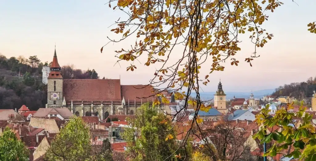 View of Brasov in Autumn - The Black Church framed by autumn leaves